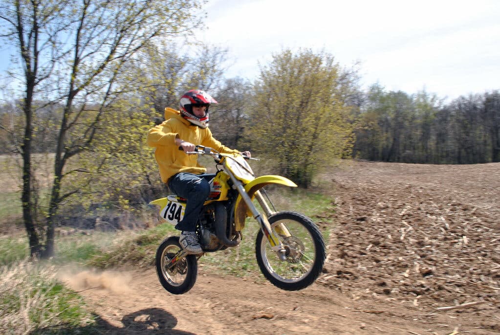 Dirt bike rider mid-ride on a track