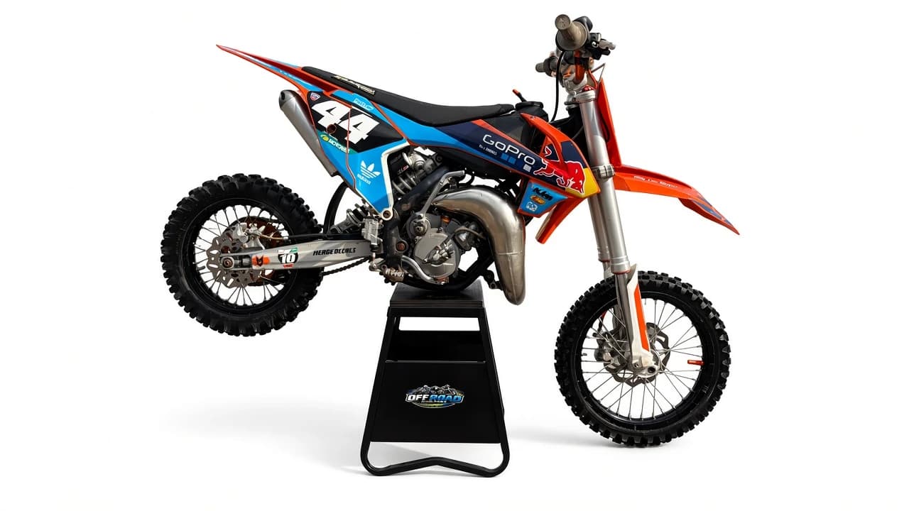 Blue and orange number 44 dirt bike on a white background