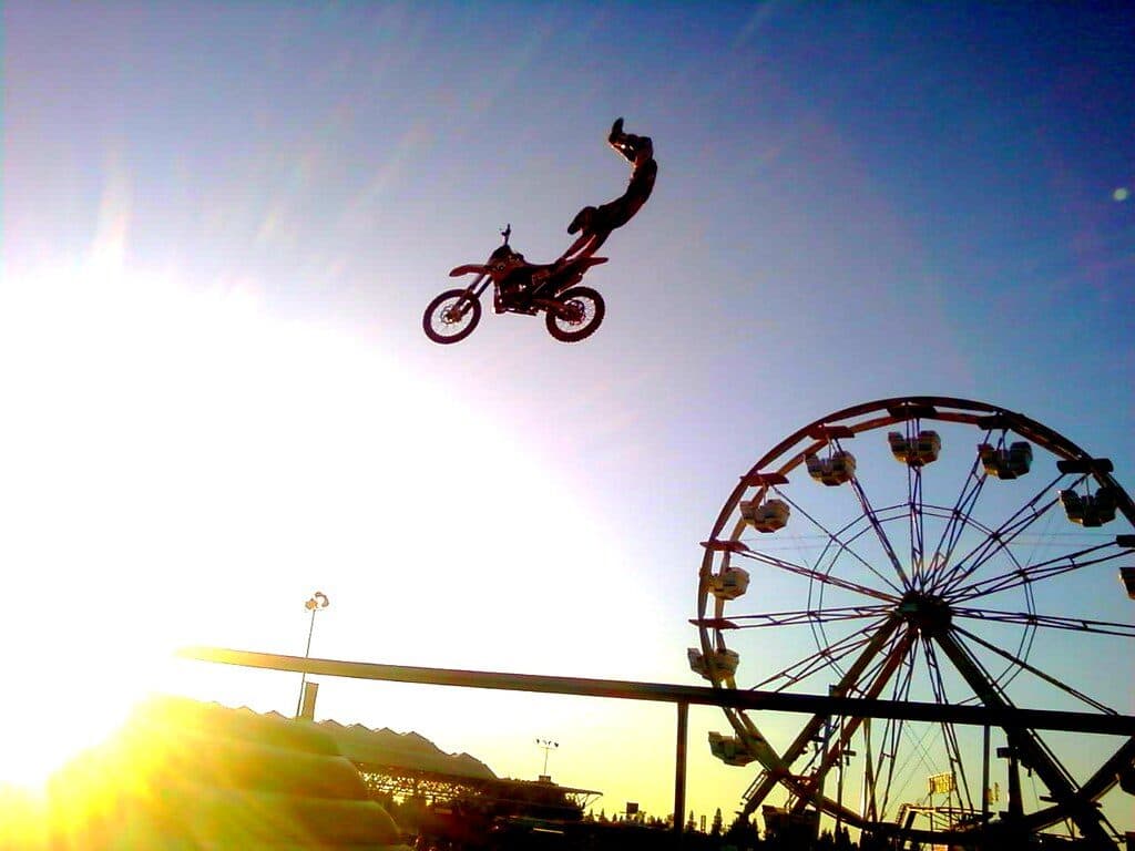 Motocross rider airborne over a dirt jump